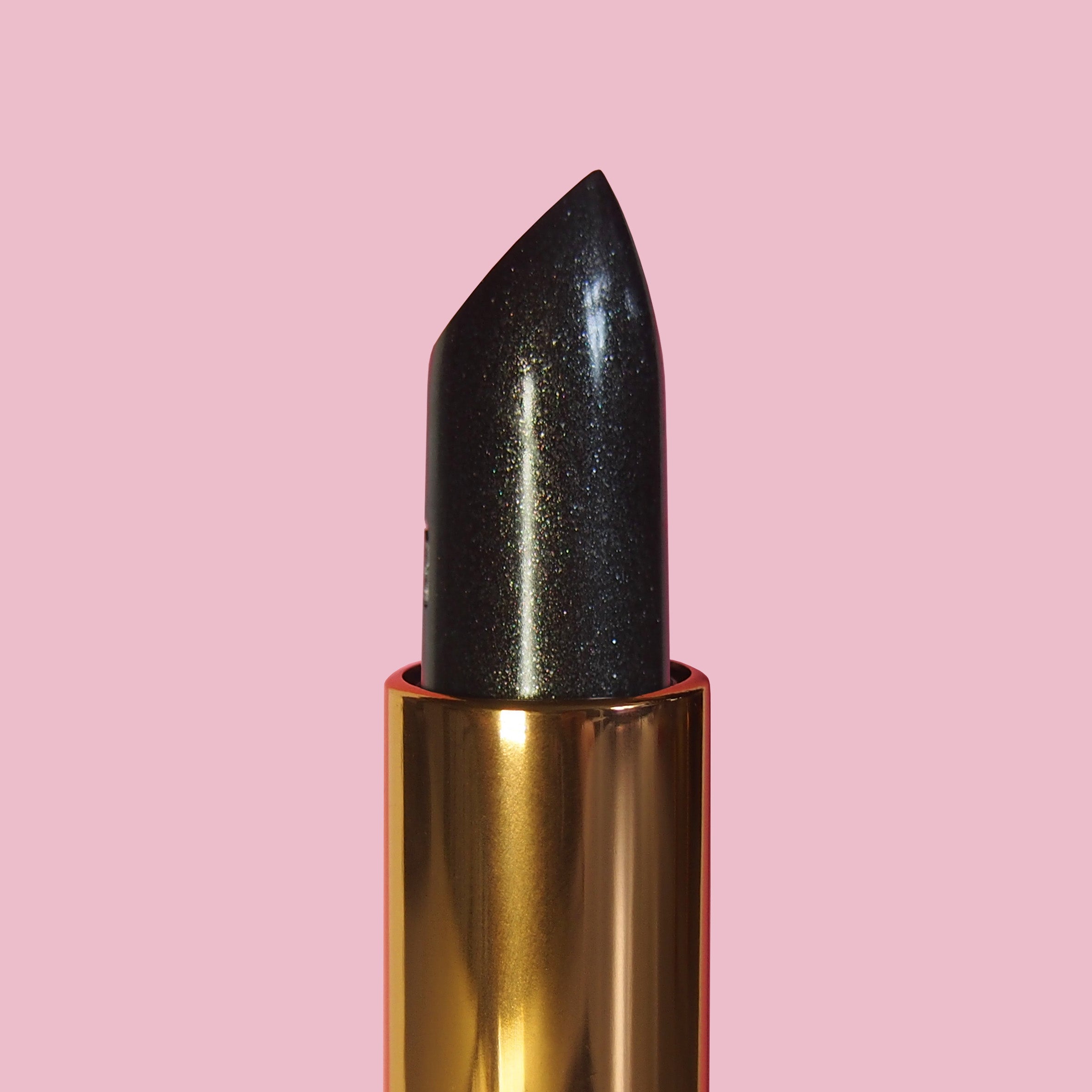 Black glittery lipstick on a pink background