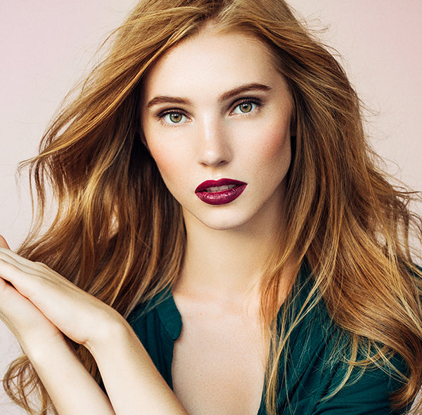 berry shade all natural lipstick on model